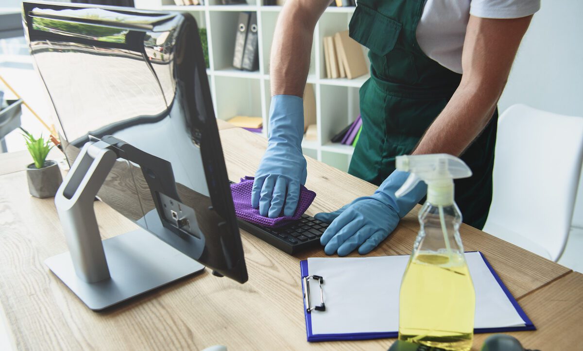 Keeping It Spotless: Professional Office Cleaning Solutions in Redwood City 1 office cleaner wiping down computer keyboard